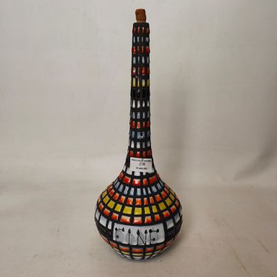 a decorative vase with a clock on it on a table