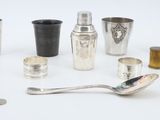 a lot of silver cups and spoons on the table