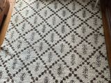 a white rug on the floor in a living room