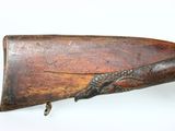 an old wooden rifle with a metal handle on a white background