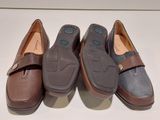 three pairs of shoes are lined up in a row on a white surface