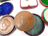 many different types of medals on a white surface