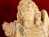 a statue of an angel on a red background