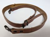 a brown leather belt with two metal buckles on it