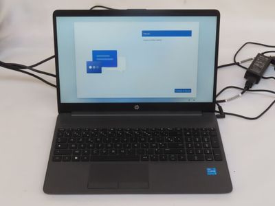 a laptop that is sitting on a table with a charger