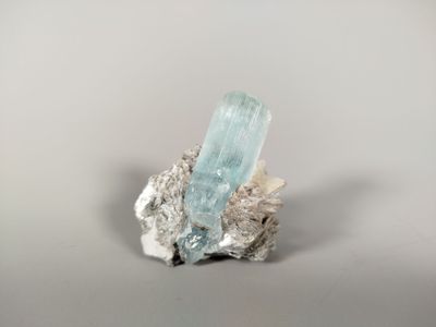 a close up of a piece of rock with a crystal on it