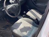 a car that is sitting in the dirt with its door open