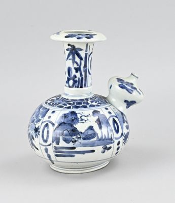 a blue and white vase with a bird on it
