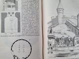 an open book with a drawing of a castle on it