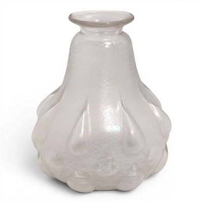 a glass vase that is sitting on a white surface