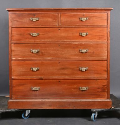 an old wooden chest of drawers on wheels against a gray background