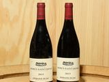 deux bouteilles de vin posées sur un tonneau