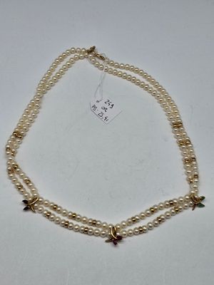 two strand pearl necklace with star charms on a white background