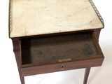 a small wooden table with a drawer on it
