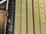 several books are stacked on top of each other on a table