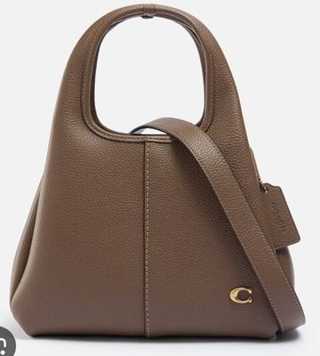 a brown leather handbag with a gold logo on the front