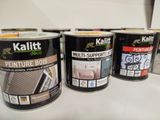 three cans of paint sitting on top of a counter next to each other