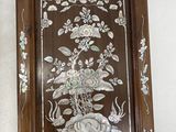 two framed pictures of flowers and birds on the wall