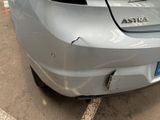 a car that has been dented and is parked in a parking lot