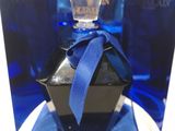 blue glass perfume bottle with a blue ribbon tied around it