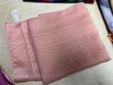 three pieces of pink fabric on a table next to a pair of scissors and a pair of scissors