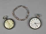 three different types of pocket watches on a table