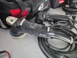 a corded sander and a bag of tools on a table