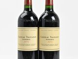 two bottles of wine sitting next to each other on a table