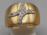 a close up of a gold ring with diamonds on it