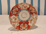 a red and blue plate sitting on a white table
