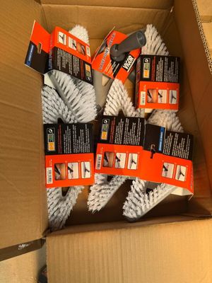a box full of cleaning brushes and a pair of scissors