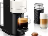 an image of a coffee maker with a cup of coffee next to it