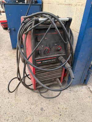 a welding machine that is sitting on the ground