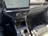 the interior of a car with a touch screen and steering controls