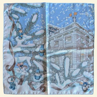 un gros plan sur une écharpe ornée d'une image représentant une maison dans la neige