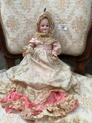 a doll that is sitting on a chair
