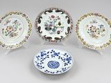 four chinese porcelain plates with floral designs on them