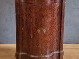 a wooden cabinet with a marble top on a wooden floor