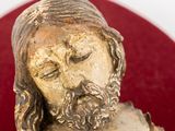 a statue of a man with a beard on a red plate