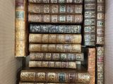 a box full of old books sitting on top of each other