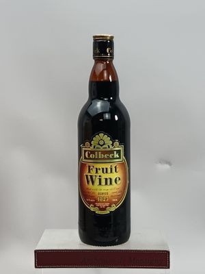 une bouteille de vin de fruits posée sur une boîte