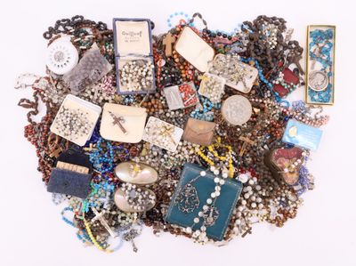 a pile of assorted jewelry on a white surface
