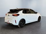 the rear end of a white toyota corollant parked in a room