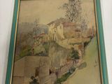 tableau accroché au mur d'une maison, dans un cadre vert