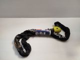 a black rope with a yellow handle on a white table