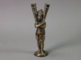 an image of a statue of a woman holding two vases