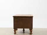 a small wooden table with a drawer on top of it