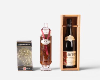 a bottle of liquor next to a box of chocolates