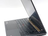 a laptop that is open on a white surface