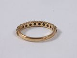 a gold ring with black dots on it
